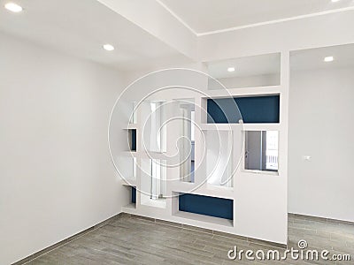 The idea of â€â€¹â€â€¹a white empty minimalist room interior with light, and a large wall and white landscape in the window. Stock Photo